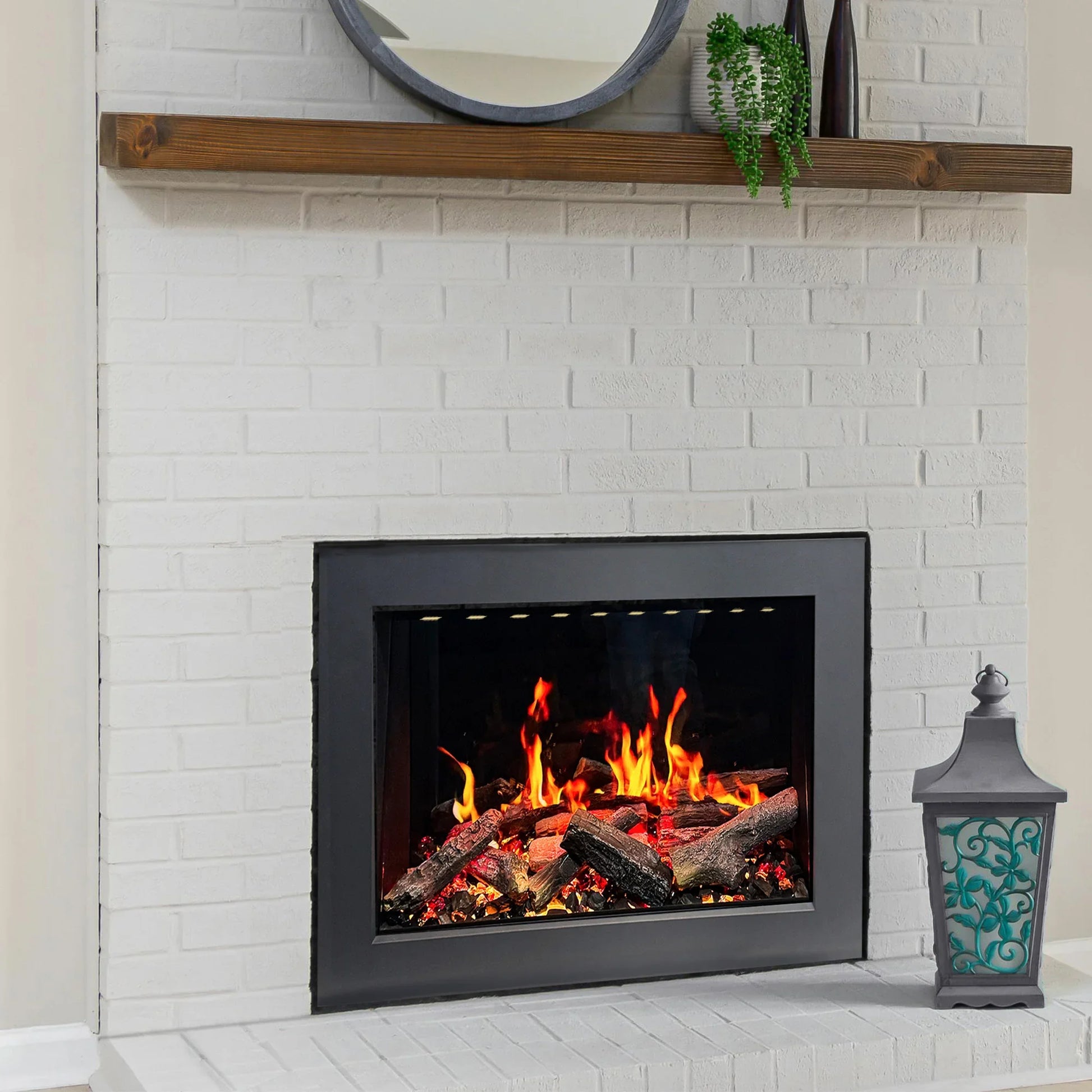 Fireplace with lit logs inside, white brick wall, wooden mantel with decor items.